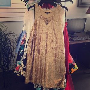 A short gold sequins dress